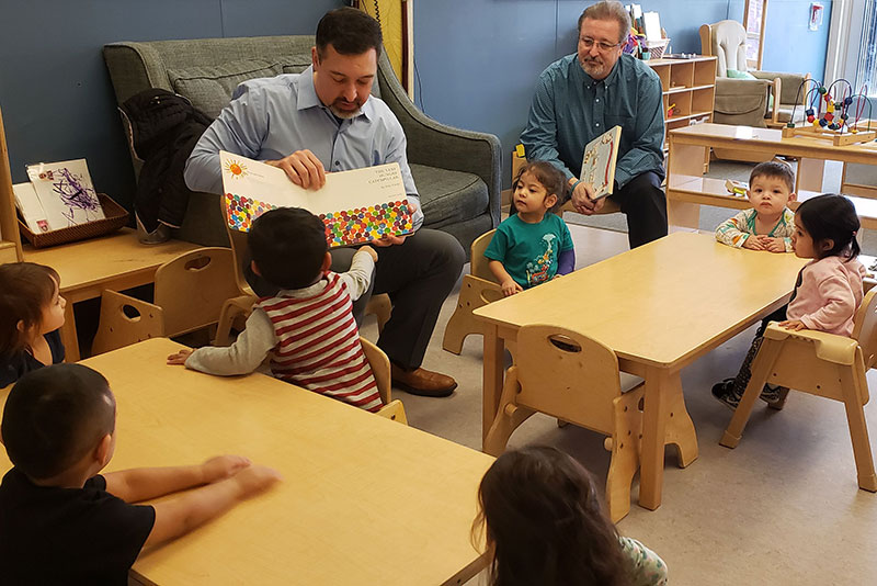 Everest State Bank
 colleagues volunteering and reading to children 