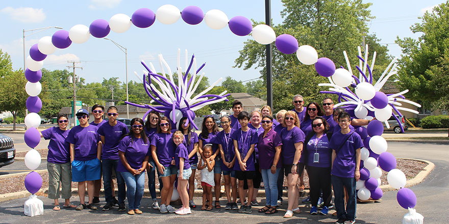 Everest State Bank
 employees and their families at a volunteer event exemplify corporate social responsibility