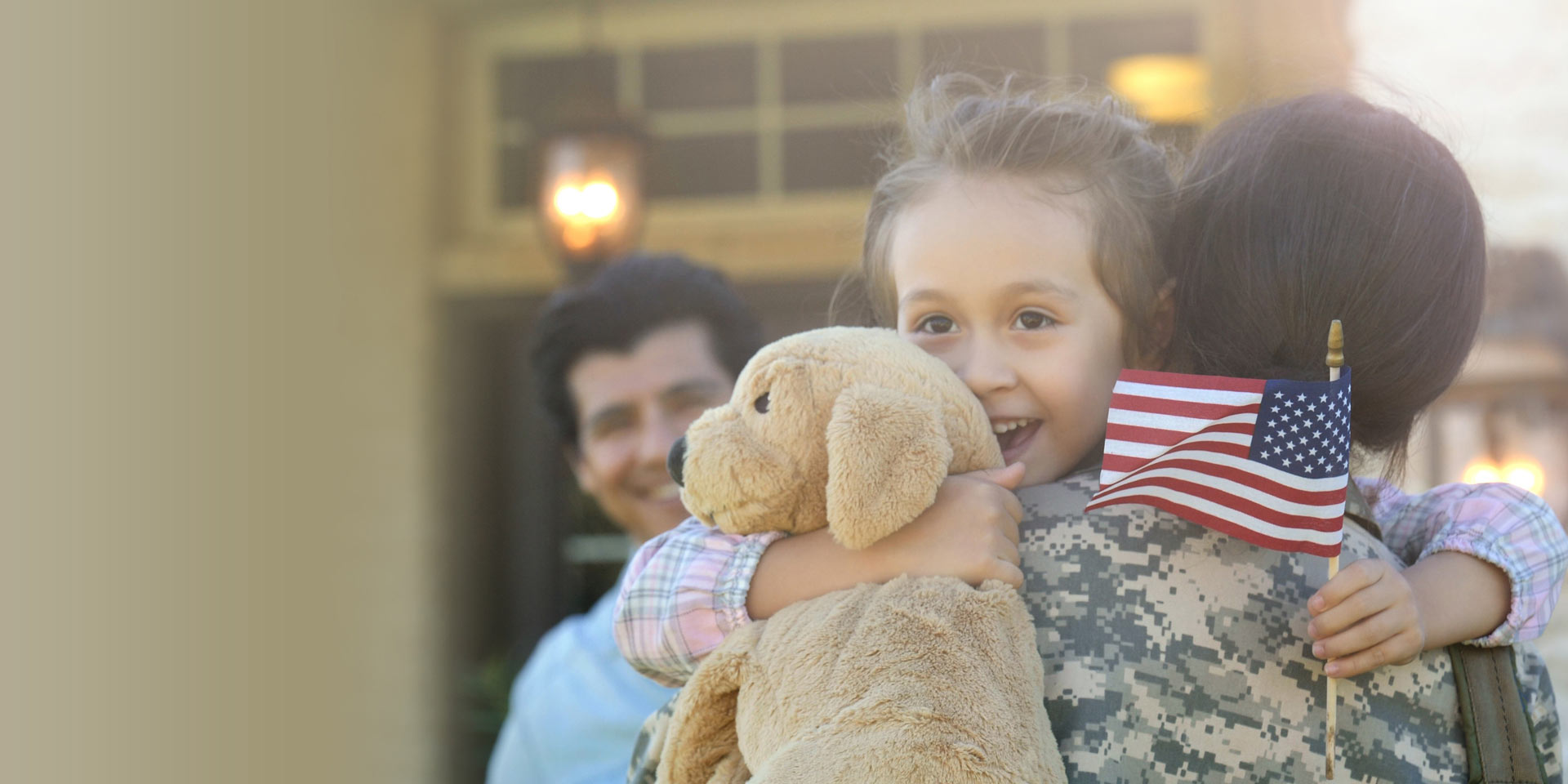 A mother in a military uniform is holding her daughter and is supported by the Servicemembers Civil Relief Act