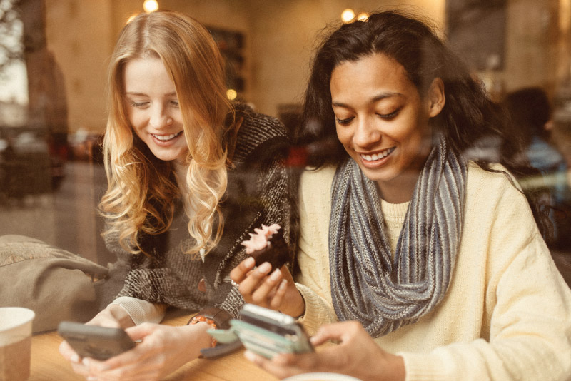 Two friends transferring money from one account to another