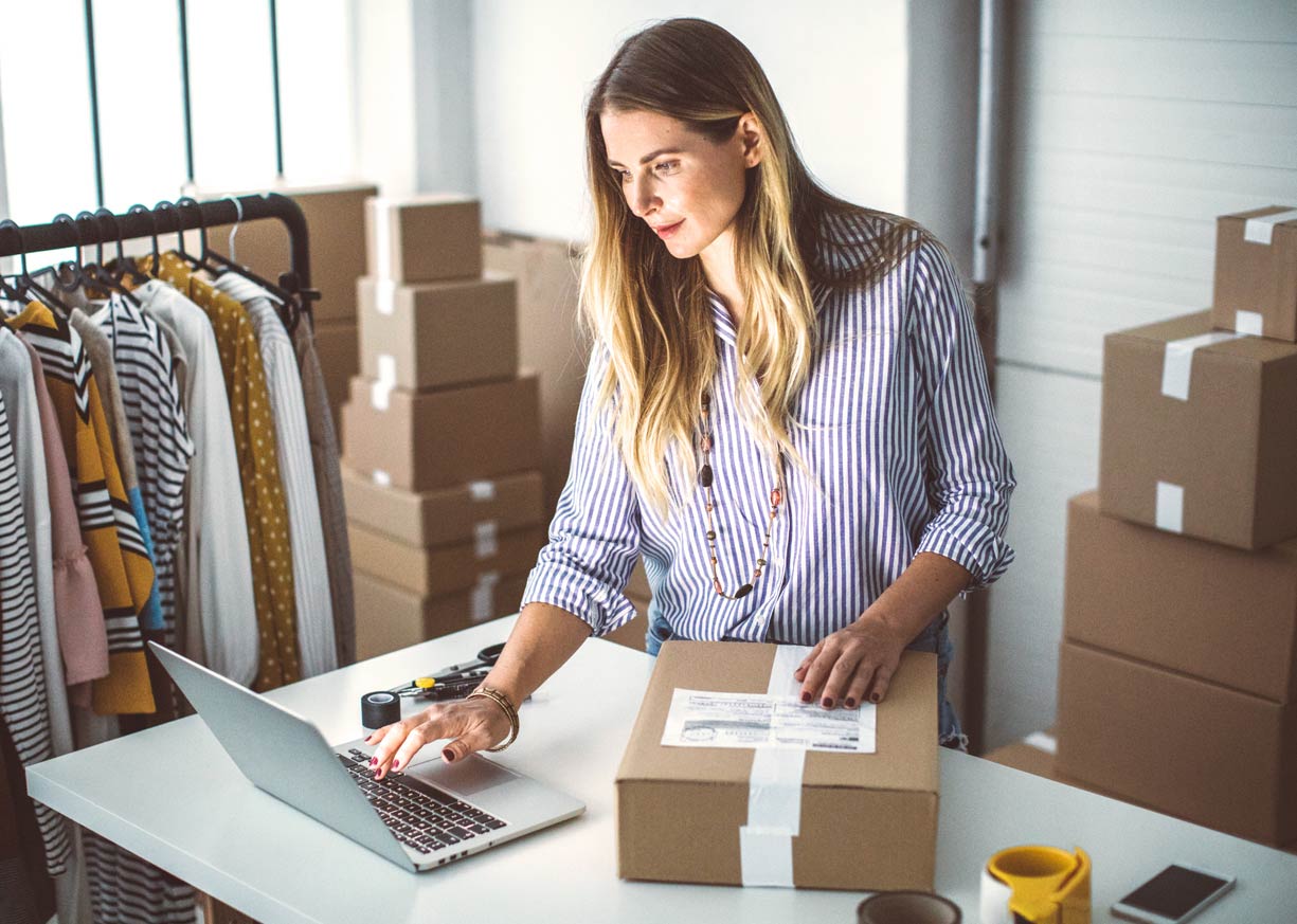 The owner of an online clothing boutique is reviewing Business Savings account rates on her laptop